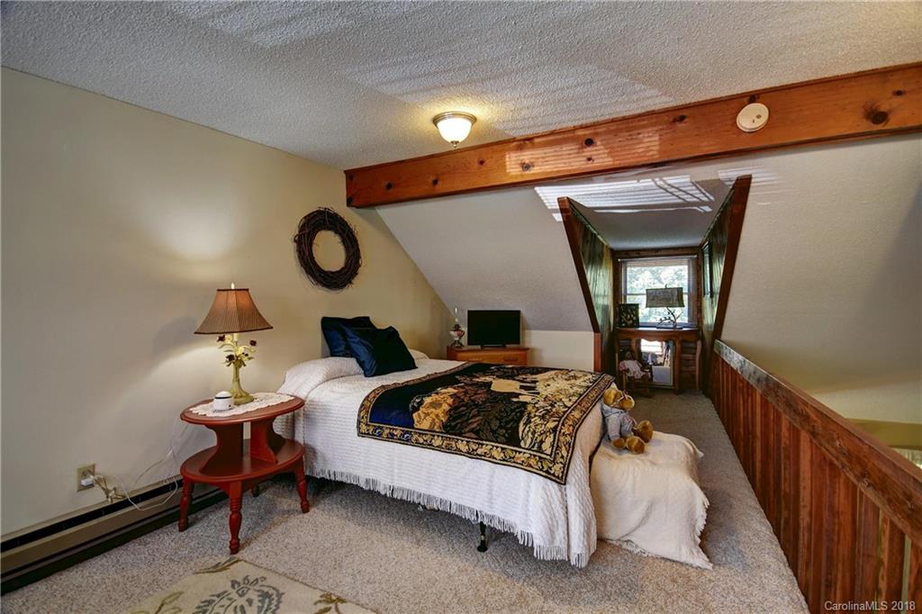 263 Laurel Branch Road Maggie Valley, NC 28751 - Photo 17 of 32 a bedroom with bed and a window