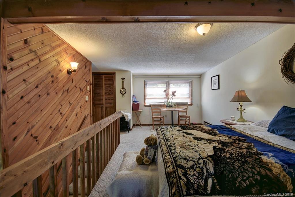 263 Laurel Branch Road Maggie Valley, NC 28751 - Photo 18 of 32 a bedroom with a bed and a window