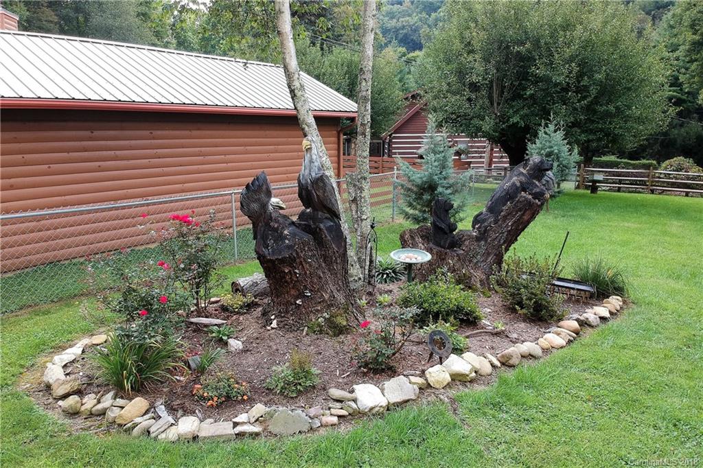 263 Laurel Branch Road Maggie Valley, NC 28751 - Photo 4 of 32 a backyard of a house with lots of green space