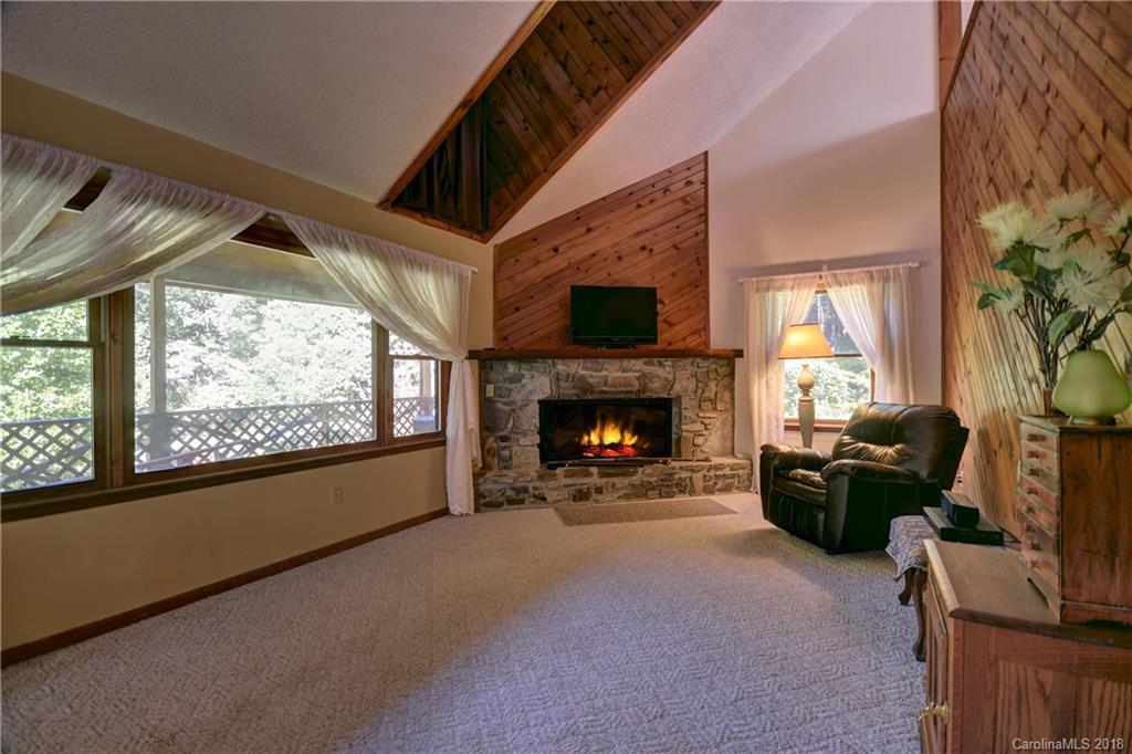 263 Laurel Branch Road Maggie Valley, NC 28751 - Photo 9 of 32 a living room with furniture and a fireplace