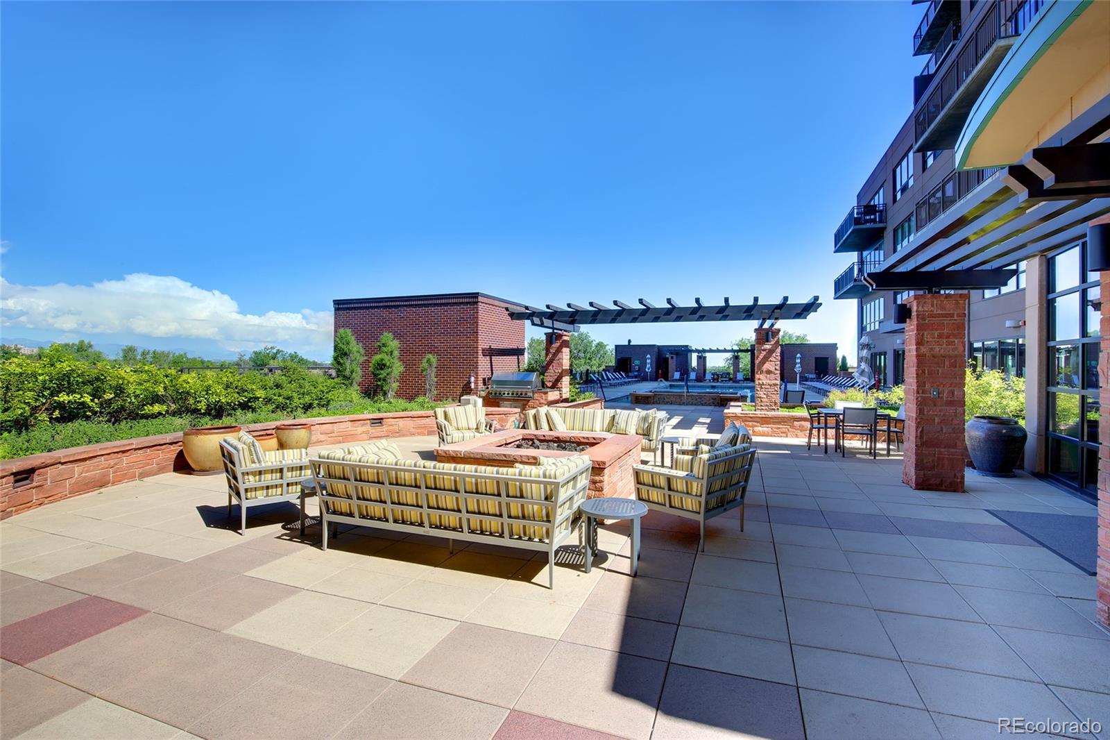 1650 Fillmore Street, Unit 1107 Denver, CO 80206 - Photo 39 of 49 a view of a patio with dining table and chairs with a barbeque grill and plants