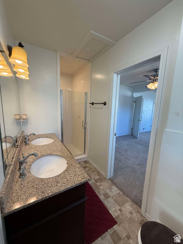 73 Garden Street Helper, UT 84526 - Photo 31 of 36 Full bath with double vanity, light carpet, a stall shower, stone finish floors, and ceiling fan