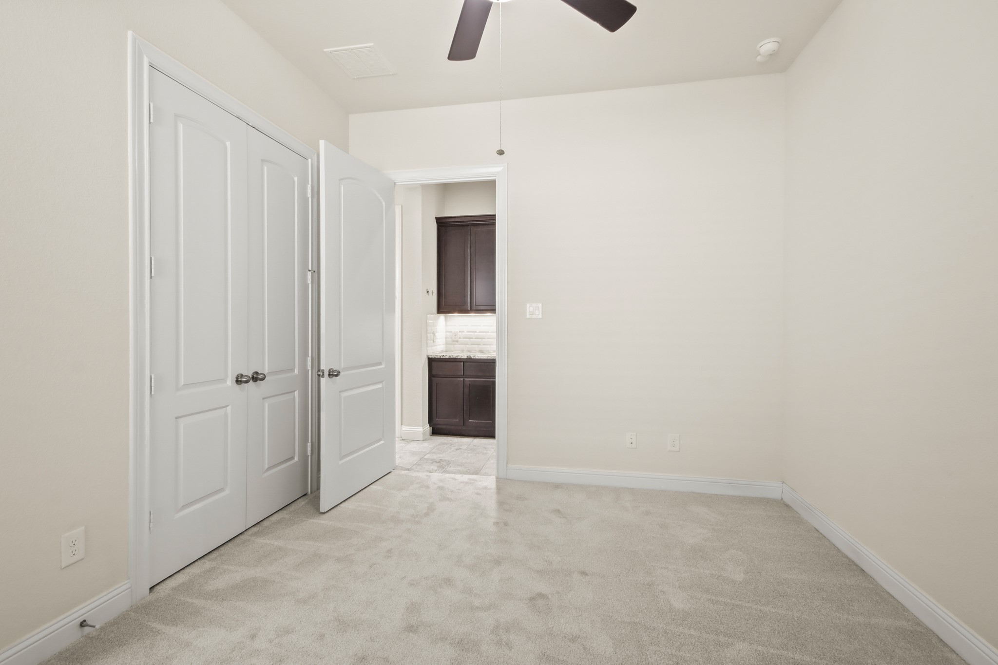 8931 Leaning Hollow Lane Spring, TX 77379 - Photo 23 of 38 View looking out from the secondary bedroom towards the hallway to the garage.