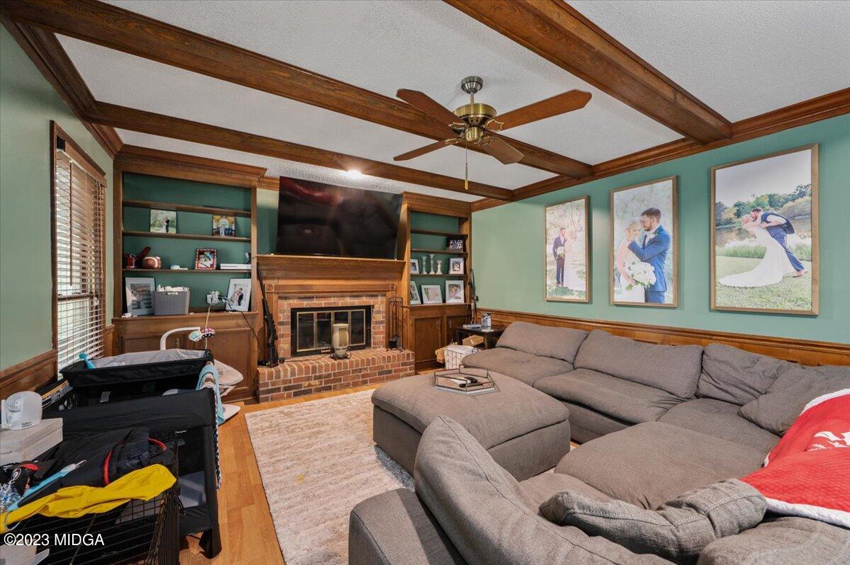 347 Castlegate Road Macon, GA 31210 - Photo 11 of 34 a living room with furniture a fireplace and a flat screen tv