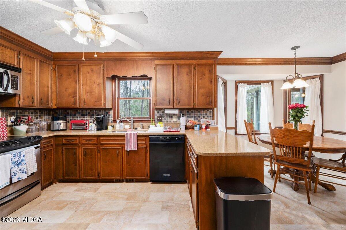 347 Castlegate Road Macon, GA 31210 - Photo 16 of 34 a kitchen with kitchen island granite countertop a cabinets sink and a stove