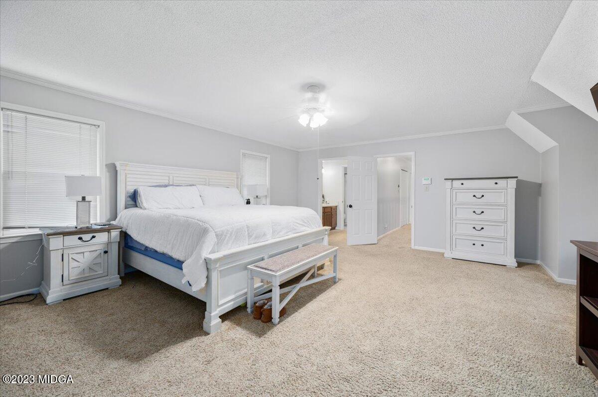 347 Castlegate Road Macon, GA 31210 - Photo 20 of 34 a bedroom with a bed and a chandelier
