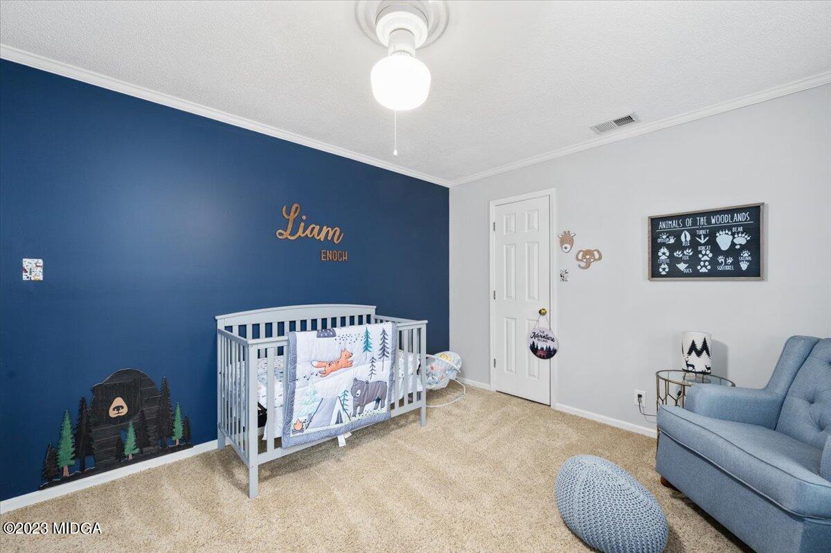 347 Castlegate Road Macon, GA 31210 - Photo 23 of 34 a bed room with a bed and a couch