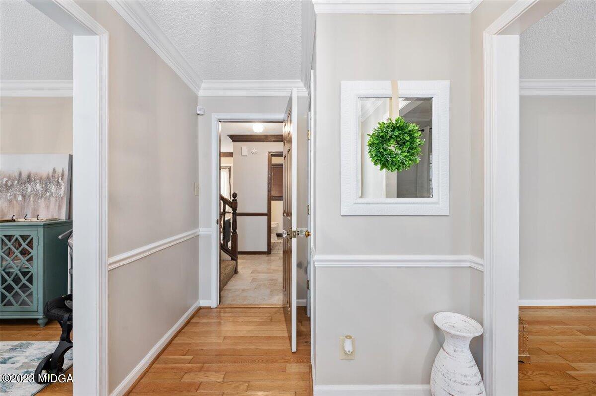 347 Castlegate Road Macon, GA 31210 - Photo 5 of 34 a view of hallway with livingroom and wooden floor