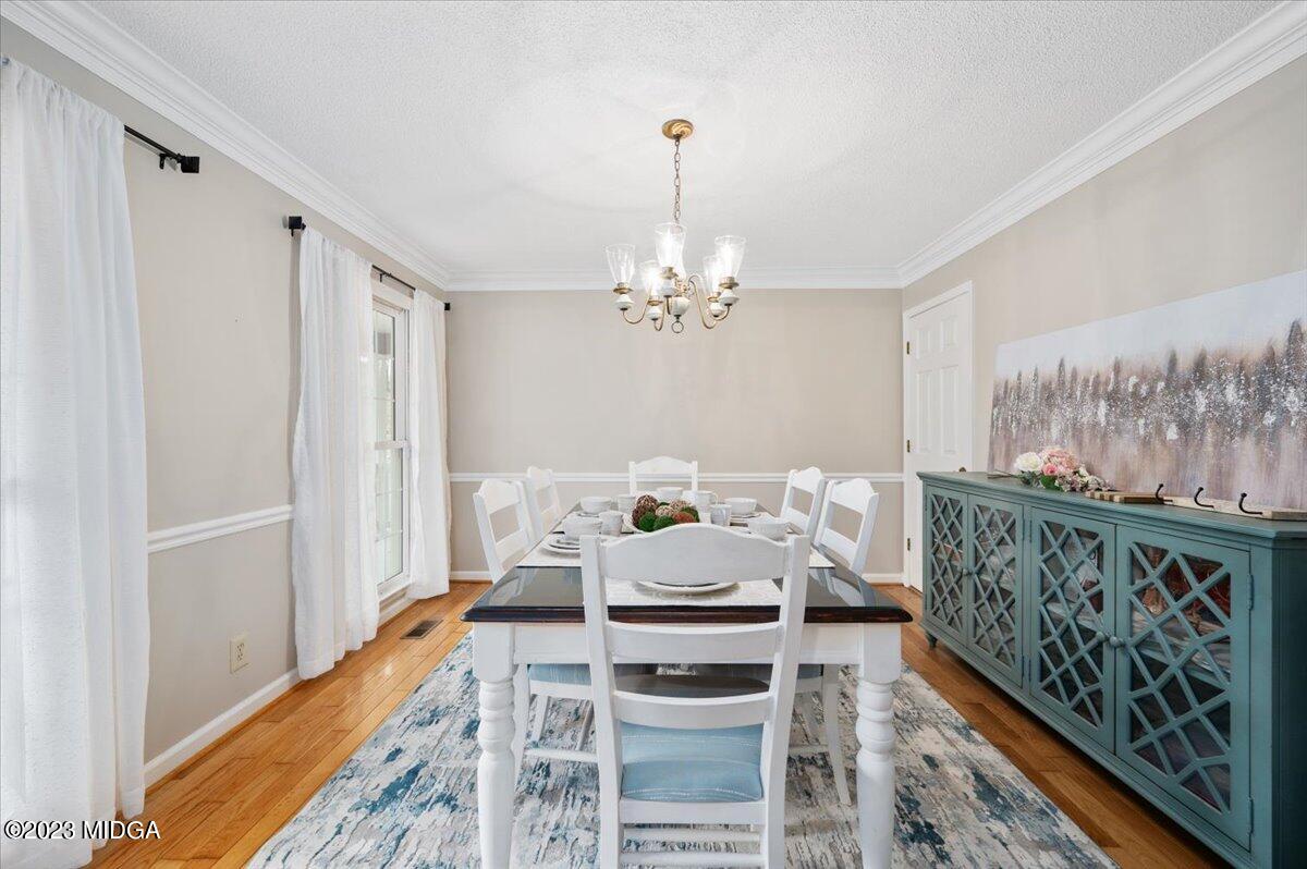347 Castlegate Road Macon, GA 31210 - Photo 8 of 34 a bed room with a bed and a chandelier