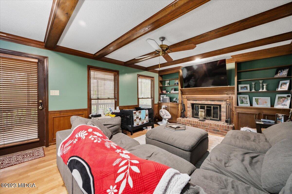 347 Castlegate Road Macon, GA 31210 - Photo 10 of 34 a living room with furniture fireplace and a flat screen tv