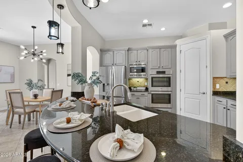 a view of a dining room with furniture and a chandelier