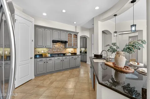 a kitchen with stainless steel appliances a dining table and chairs