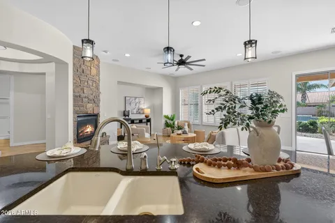 a kitchen with stainless steel appliances granite countertop a refrigerator a stove a sink a oven and white cabinets