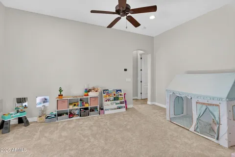 a living room with furniture and a baby crib