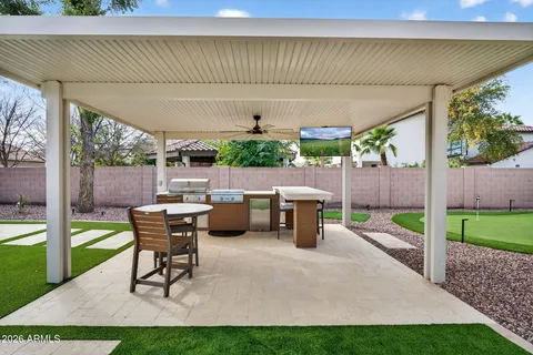 a view of a patio with table and chairs potted plants with wooden fence