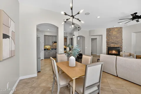 a kitchen with kitchen island granite countertop a table and chairs in it