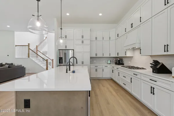 a bathroom with a sink vanity mirror and toilet