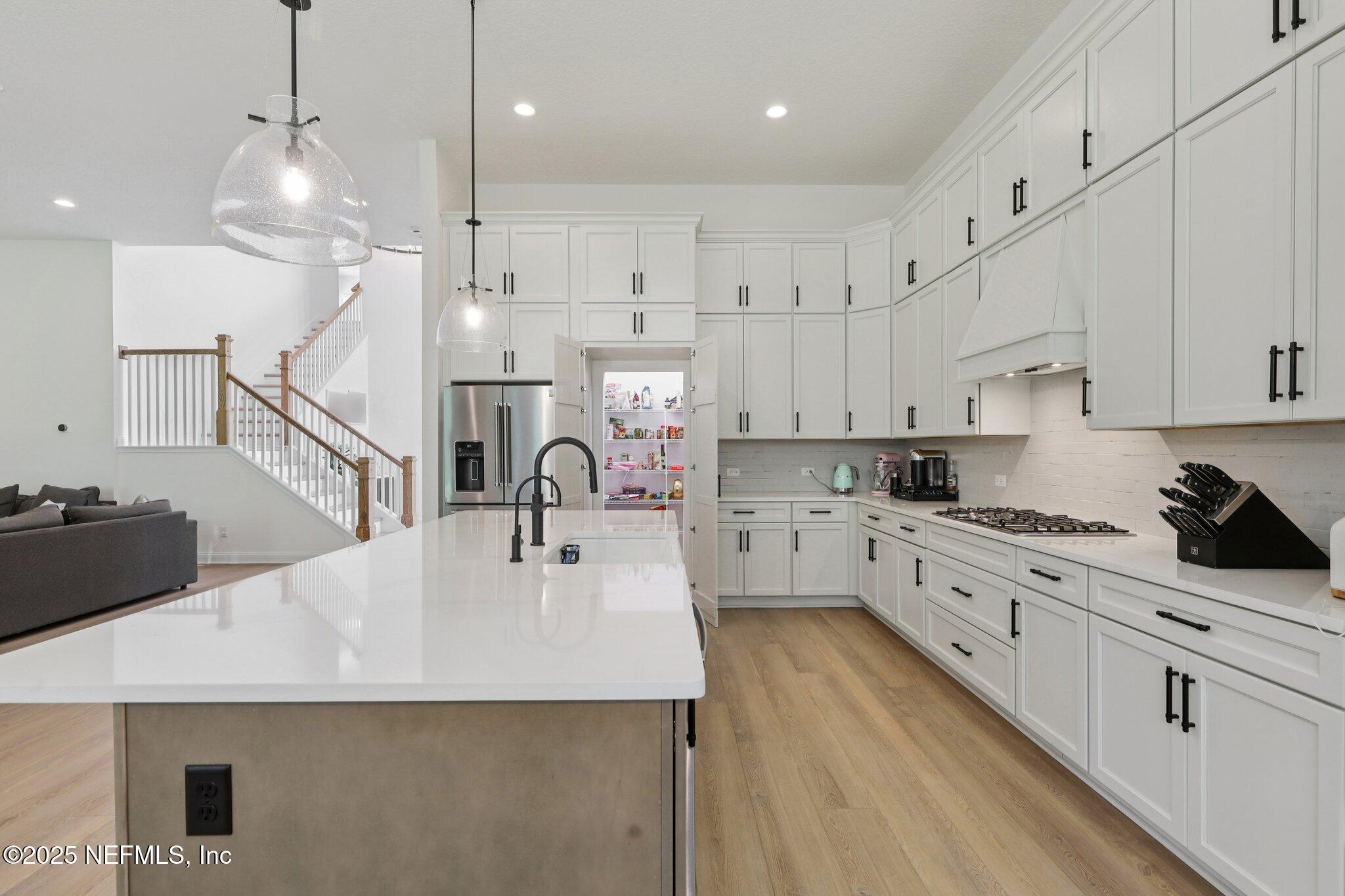 3089 Spiro Circle Jacksonville, FL 32246 - Photo 28 of 83 a kitchen with kitchen island a white counter top space cabinets and stainless steel appliances
