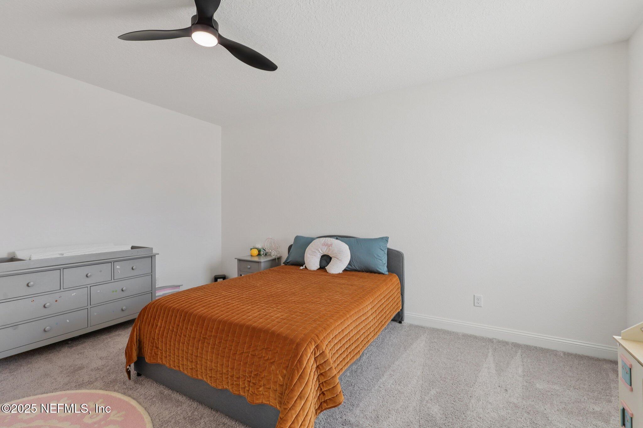 3089 Spiro Circle Jacksonville, FL 32246 - Photo 51 of 83 a bedroom with a bed and cabinet