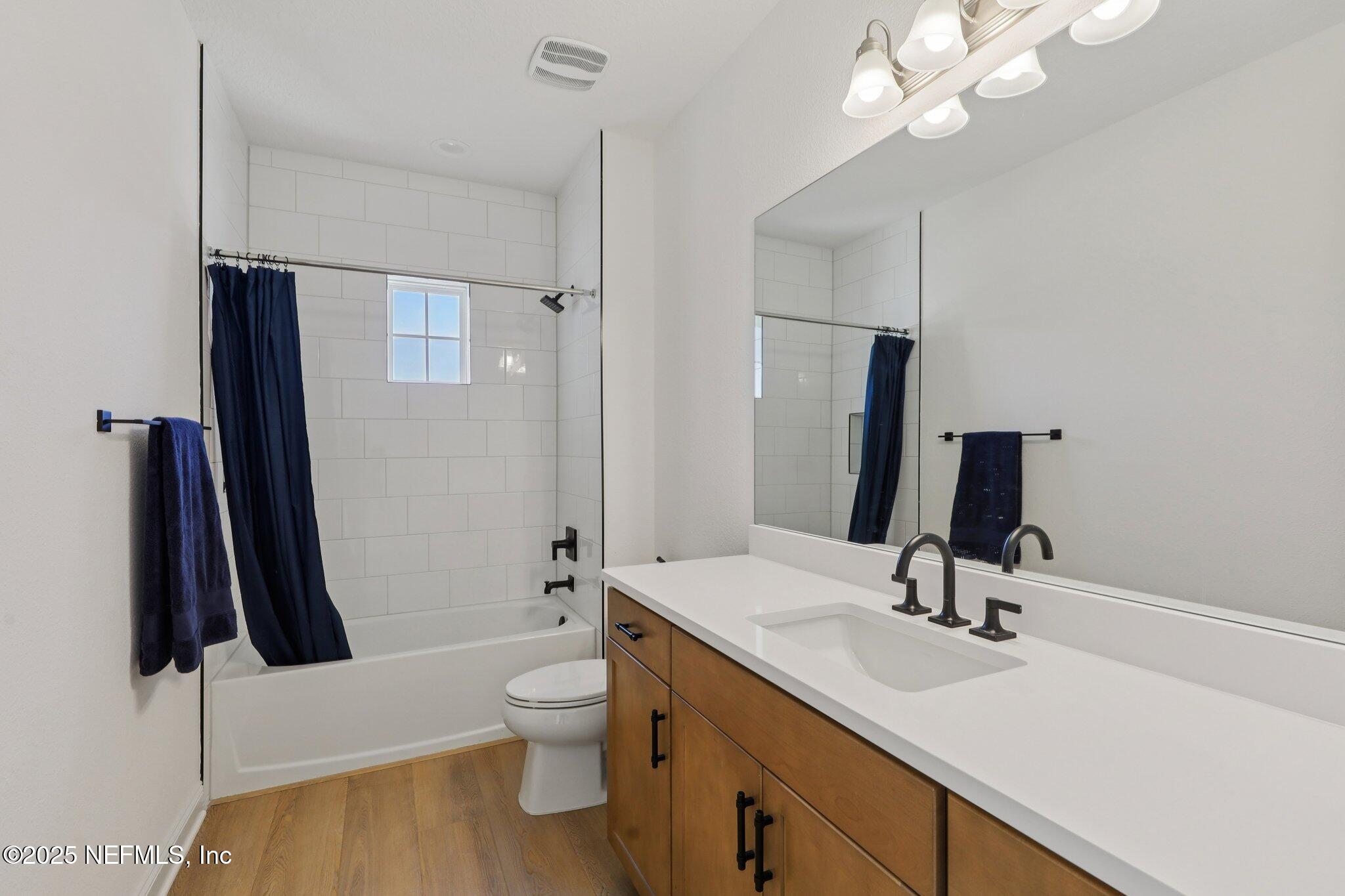 3089 Spiro Circle Jacksonville, FL 32246 - Photo 54 of 83 a bathroom with a sink a toilet and a mirror