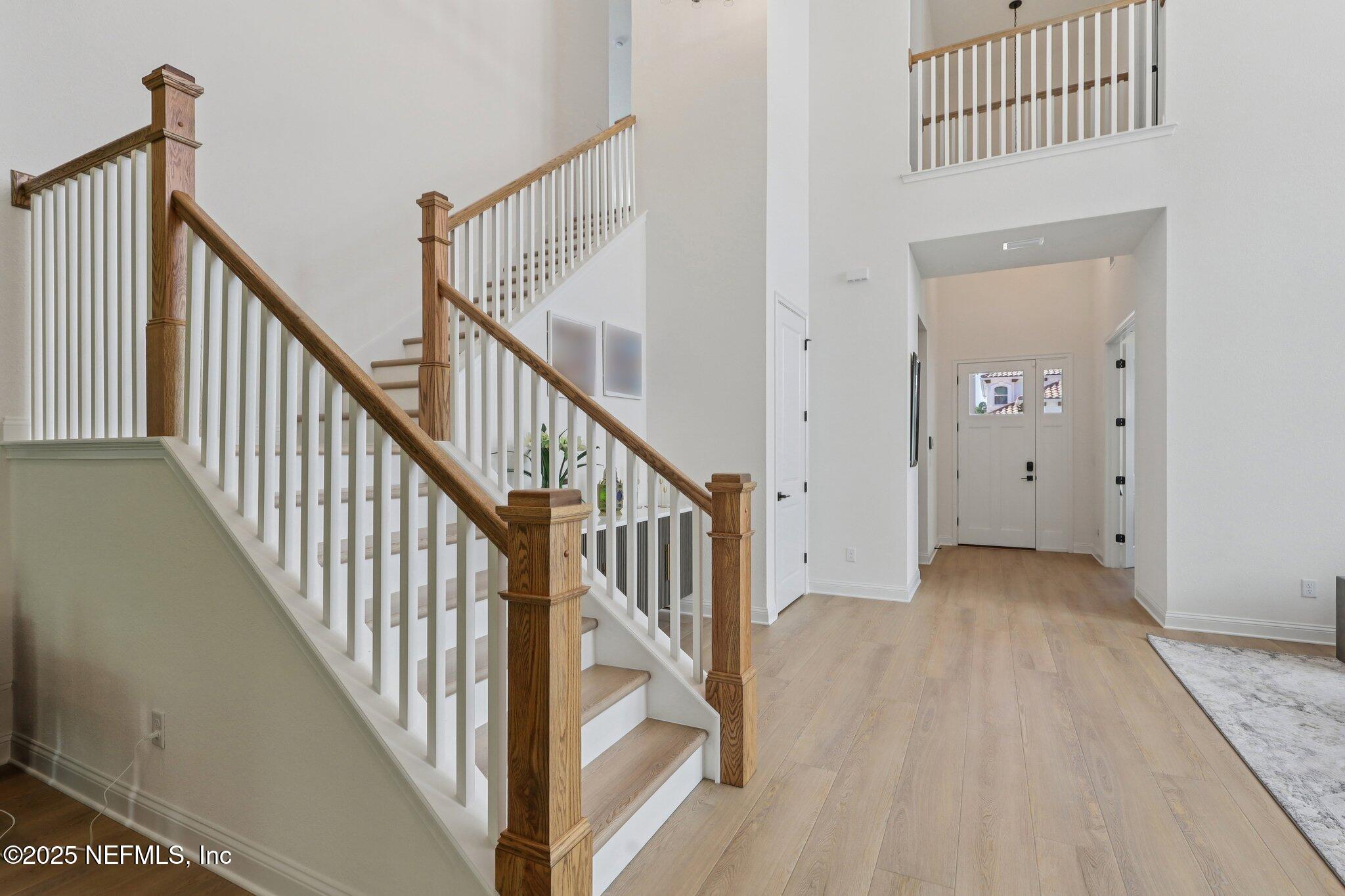 3089 Spiro Circle Jacksonville, FL 32246 - Photo 6 of 83 a view of a hallway with wooden floor and staircase