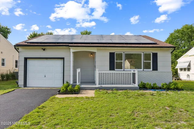 a front view of a house with a garden