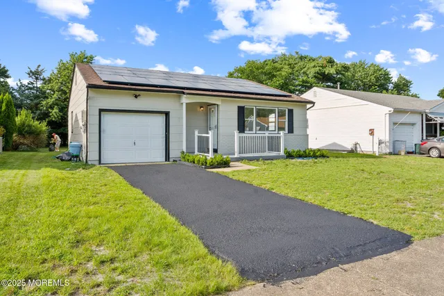 a view of a house with a yard and garage