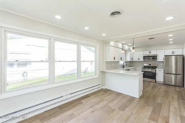 a kitchen with white cabinets and white appliances