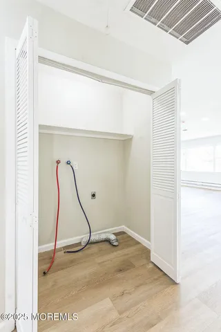 a room with a wooden floor and white walls