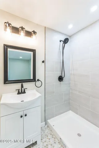 a bathroom with a sink a mirror and a bathtub