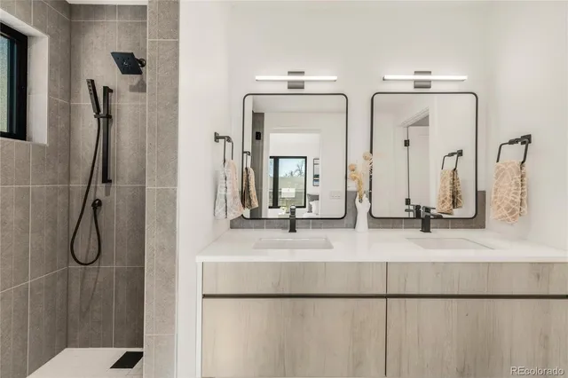 a bathroom with a double vanity sink and a mirror