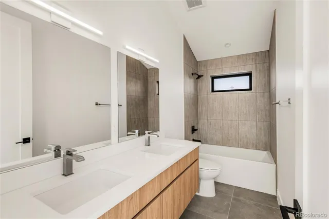 a bathroom with a tub sink and mirror