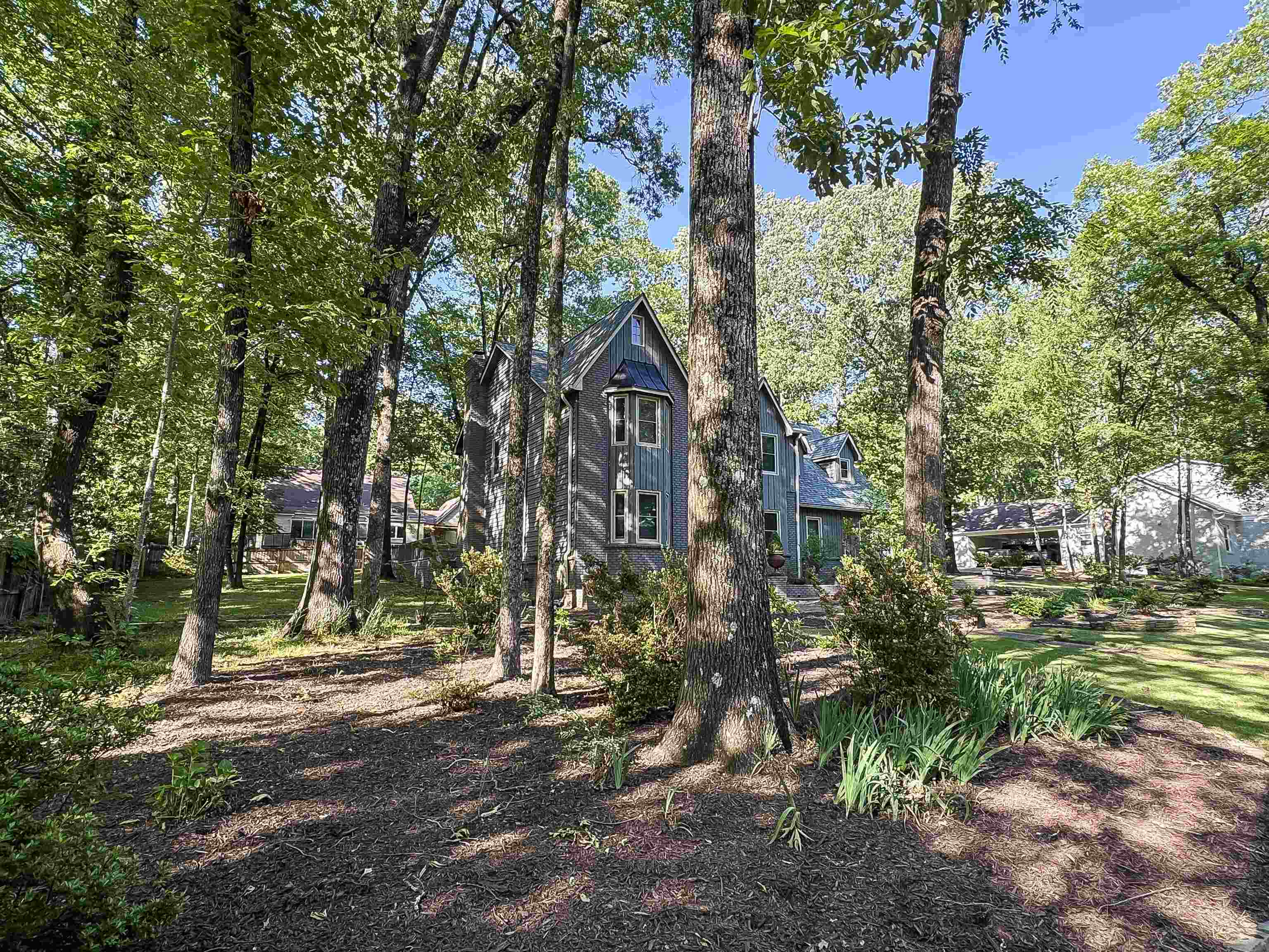 832 South Tree Drive Collierville, TN 38017 - Photo 40 of 40 Wooded property featuring a multi-story residence with gray siding and multiple gabled roofs