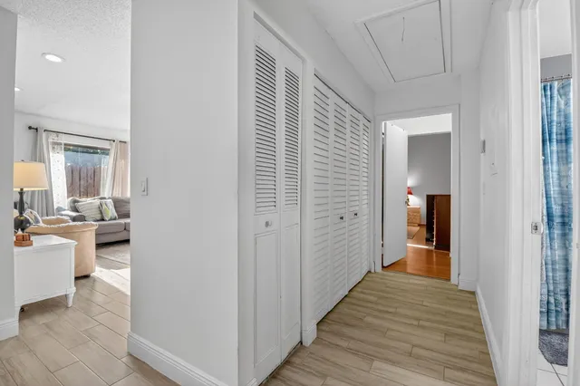 a bathroom with a bathtub shower sink vanity mirror and toilet