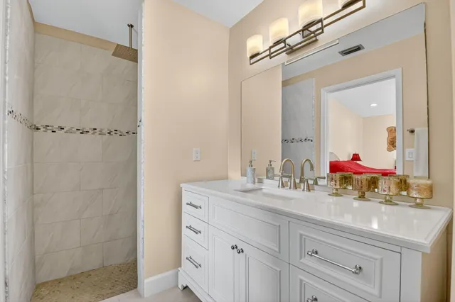 a bathroom with a double vanity sink and mirror