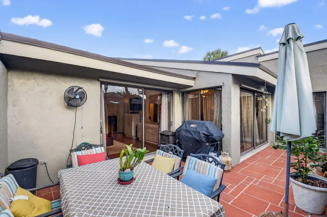 a view of balcony with chairs and wooden fence