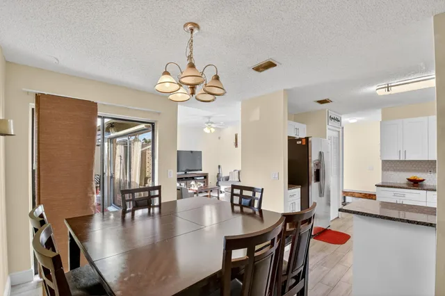 a kitchen with granite countertop a sink cabinets and stainless steel appliances