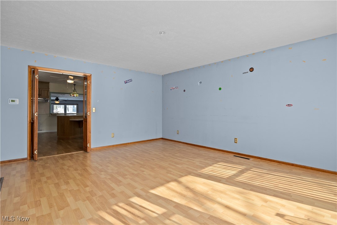 14015 West Lake Road Vermilion, OH 44089 - Photo 12 of 50 Unfurnished room featuring light wood finished floors and baseboards