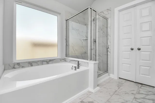 a sign that is sitting in the grass near a tree