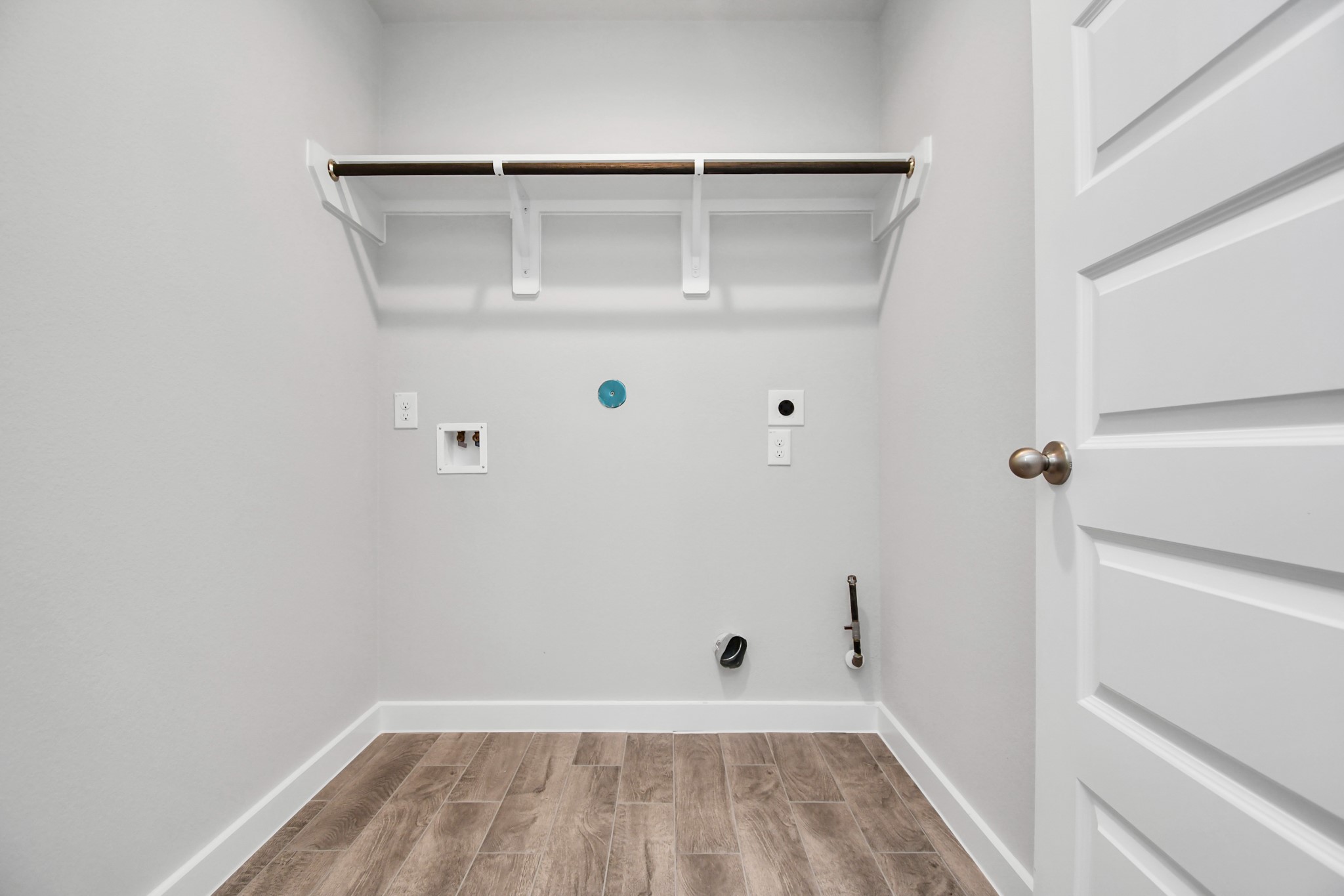 14623 Diamond Dove Lane Houston, TX 77049 - Photo 26 of 27 Laundry room, thoughtfully equipped with shelving for effortless organization. Both gas and electric dryer connections available. Sample photo of completed home with similar floor plan. As-built interior colors and selections may vary.