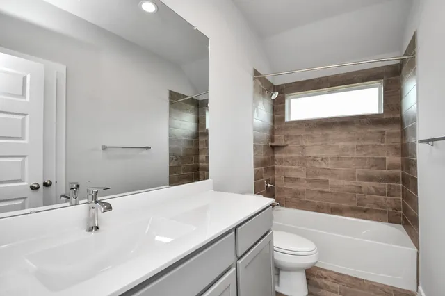 a large white kitchen with a sink and dishwasher a stove with wooden floor