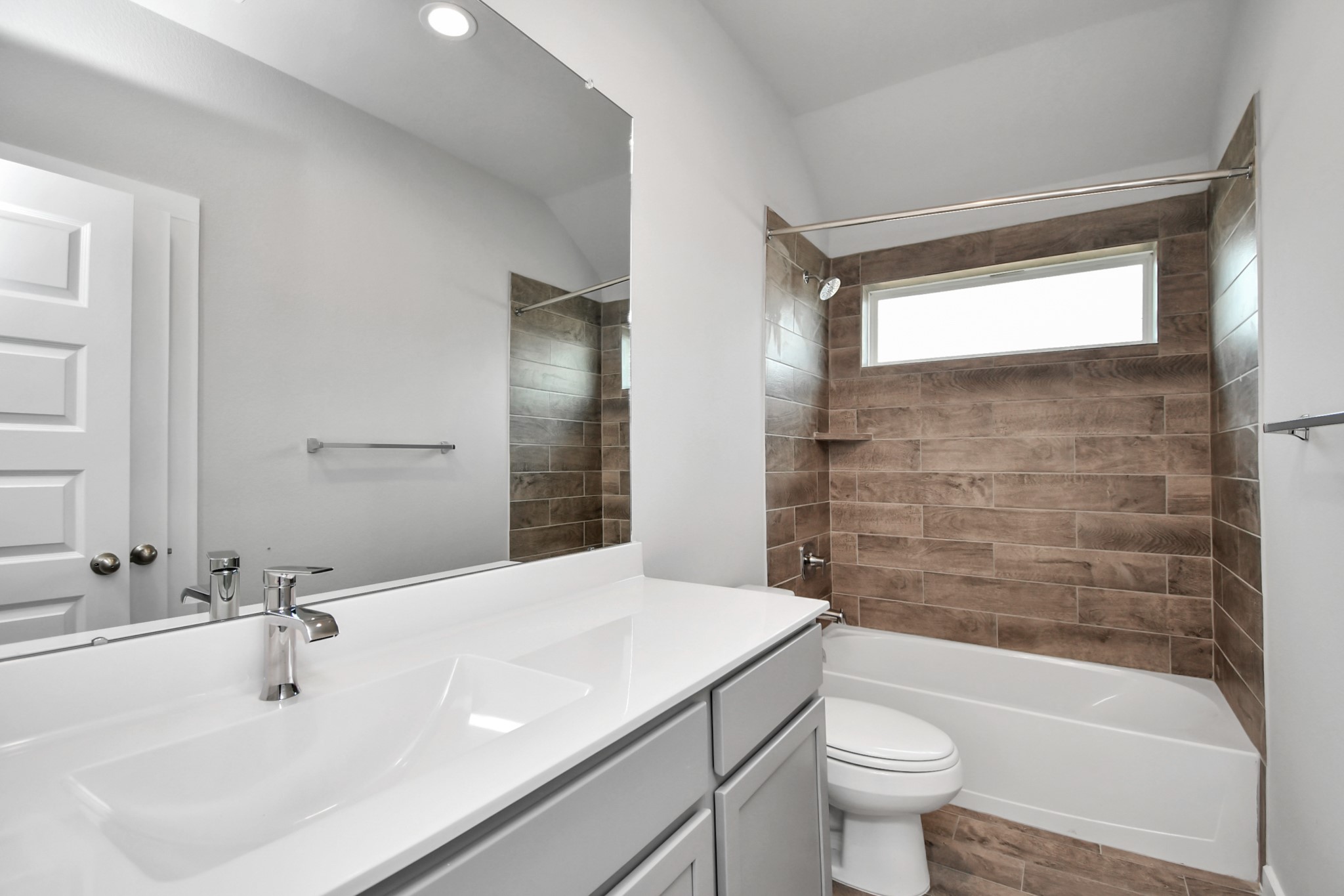 14623 Diamond Dove Lane Houston, TX 77049 - Photo 10 of 27 Secondary bath features tile flooring, bath/shower combo with tile surround, light stained wood cabinets, beautiful light countertop. Sample photo of completed home with similar floor plan. As-built interior colors and selections may vary.