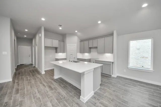 a view of an empty room with a kitchen
