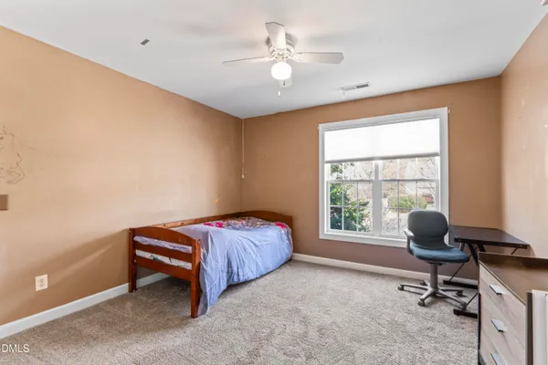 a bathroom with a toilet and a shower curtain