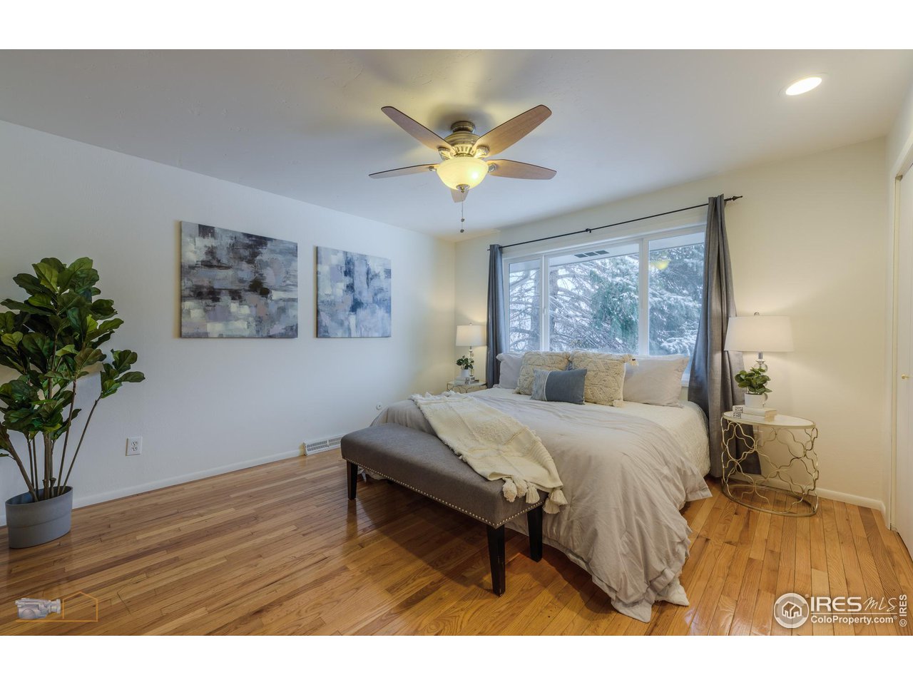 5484 Cypress Drive Boulder, CO 80303 - Photo 13 of 35 a bedroom with a bed and a chandelier