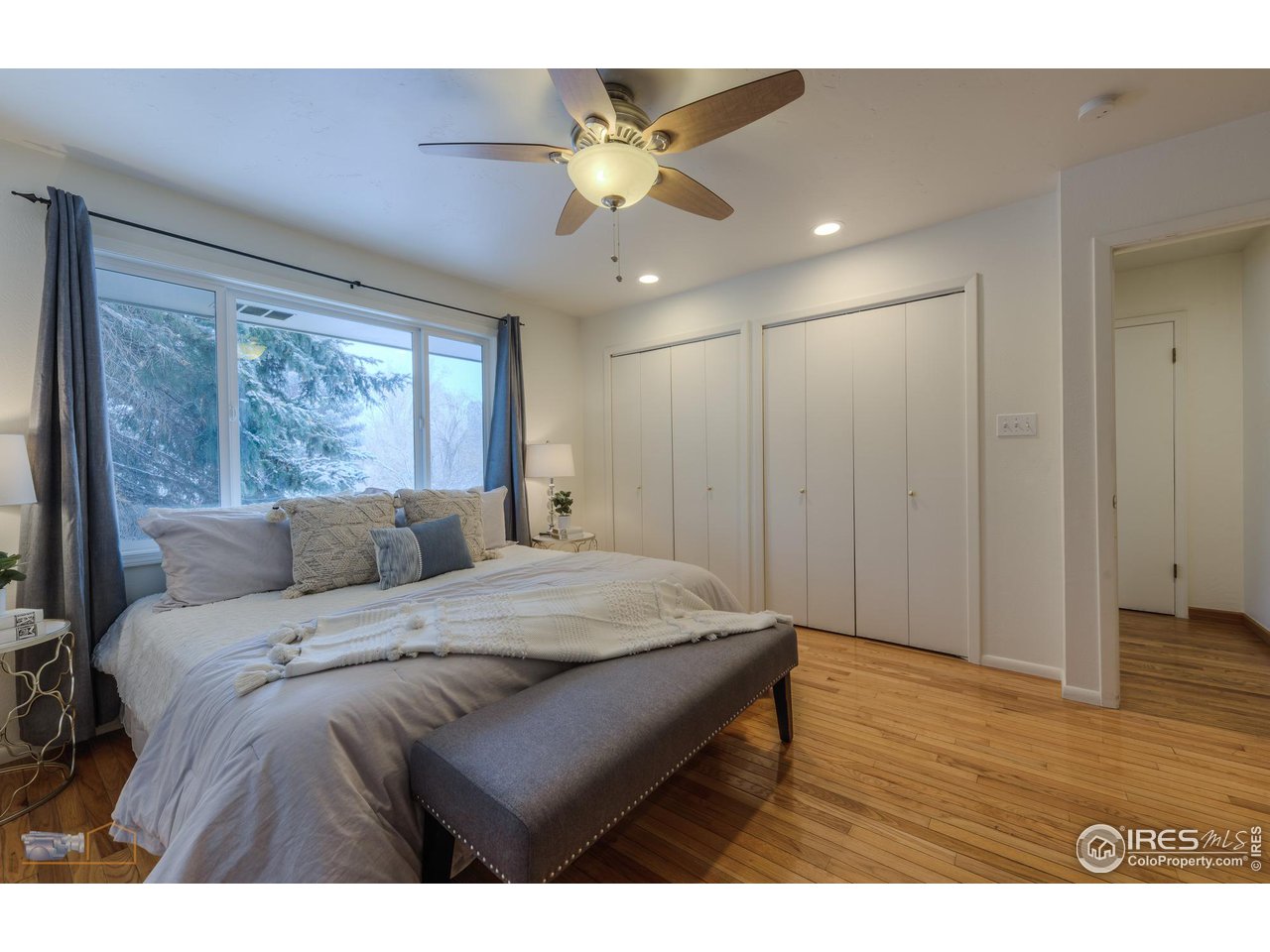 5484 Cypress Drive Boulder, CO 80303 - Photo 15 of 35 a bedroom with a bed mirror and a window