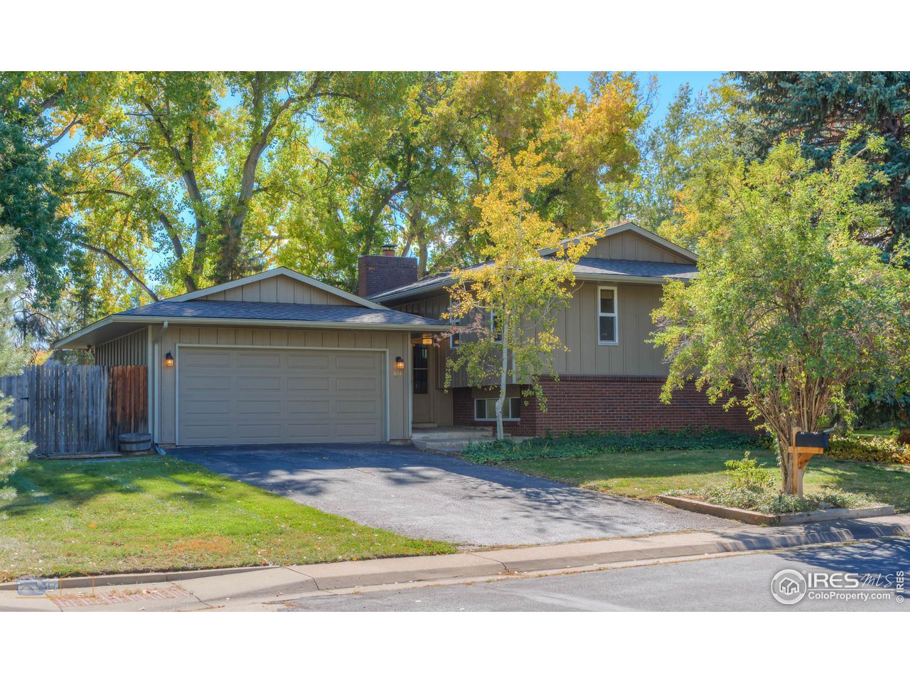 5484 Cypress Drive Boulder, CO 80303 - Photo 2 of 35 a front view of a house with a yard and garage