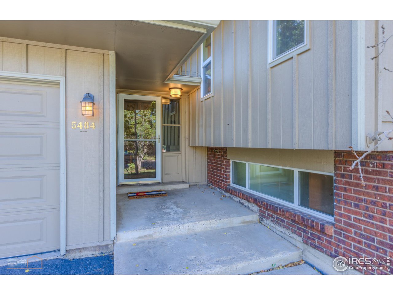 5484 Cypress Drive Boulder, CO 80303 - Photo 3 of 35 a view of an empty room with a fireplace and a window