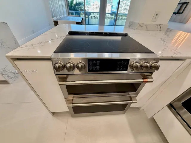 a view of a bathroom with mirror and shower