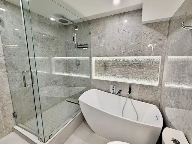 a large bedroom with a bed and window